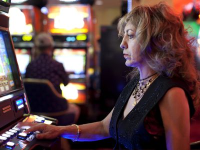 middle-aged woman gambling on electronic casino game