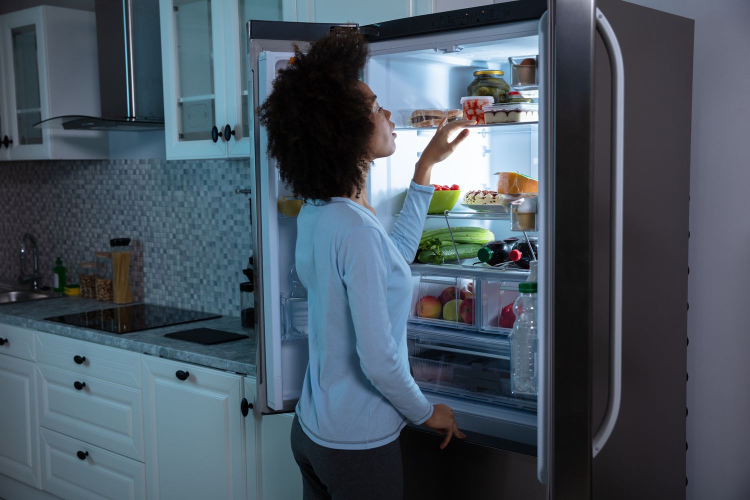 Woman looking in her refrigerator