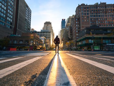 One person crossing a junction in Manhattan at sunrise, New York City