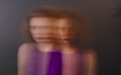 Portrait of red-haired woman, blurred, double