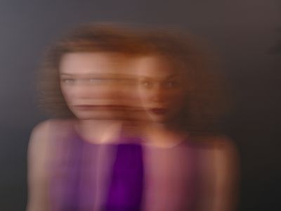 Portrait of red-haired woman, blurred, double