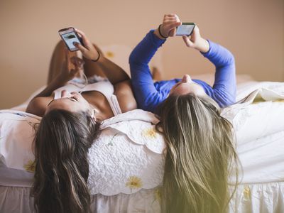 teen girls laying on bed
