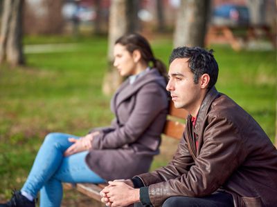 unhappy couple on park bench