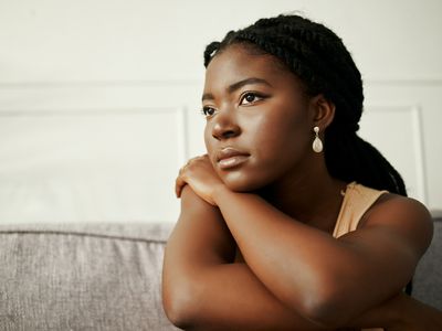 Shot of a young woman looking depressed at home