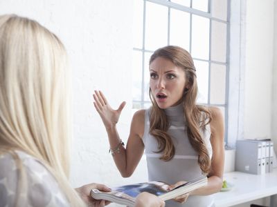 women having argument in office