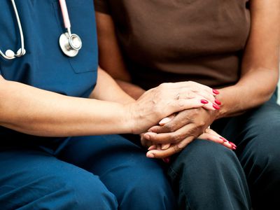 Woman holding nurse's hand