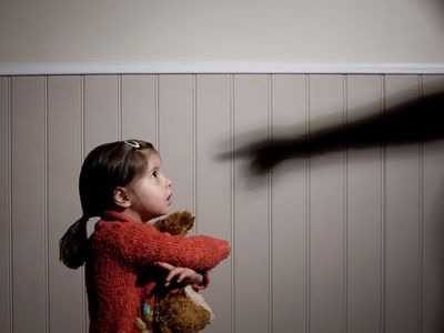 a girl being yelled at by a shadow pointing a finger