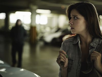 woman looking scared in parking garage