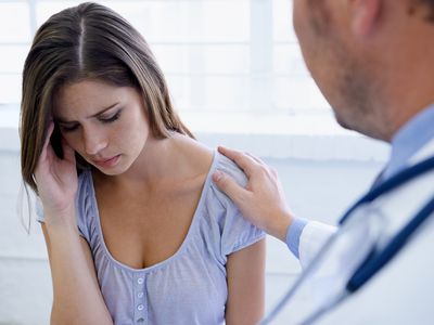 Anxious woman talking with doctor