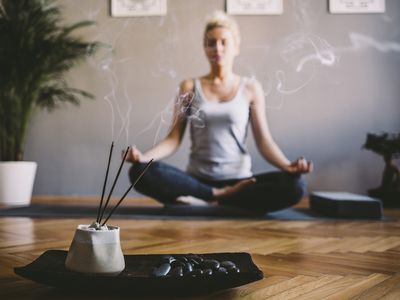 Woman meditating with incense