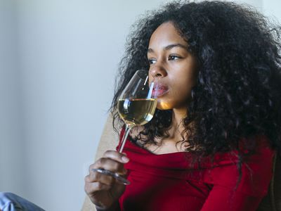 Portrait of woman drinking glass of white wine
