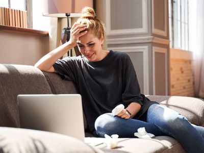 woman crying while on laptop