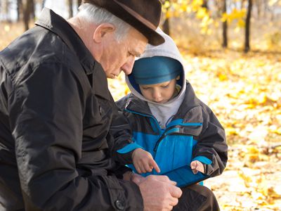 Grandfather and grandson sharing a tablet-pc