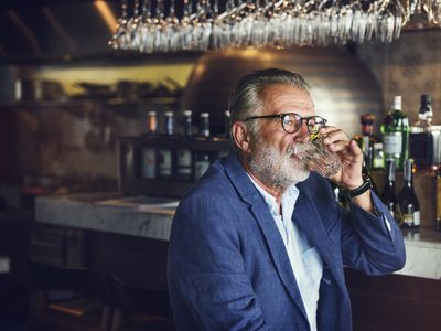 older man drinking at bar