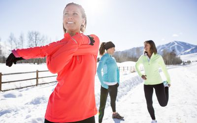 women stretching for exercise outdoors in winter