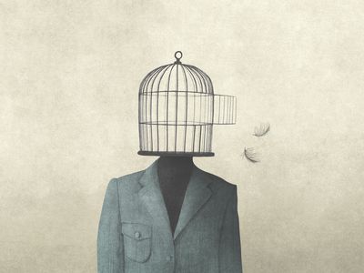Man with open birdcage over his head, surreal freedom concept
