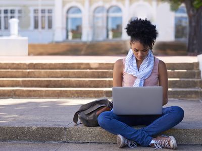 Student using laptop outside on college campus
