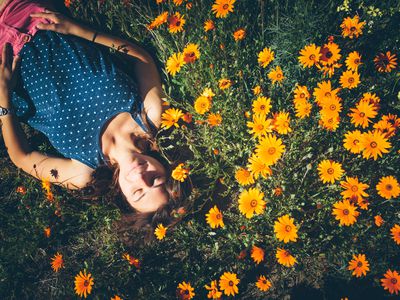 Woman lying in flower patch