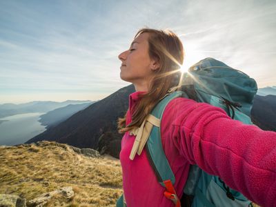woman feeling free at top of mountain