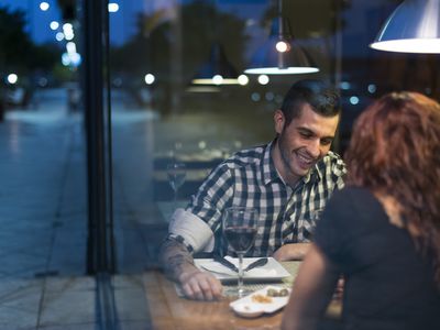 Young couple in modern restaurant having dinner